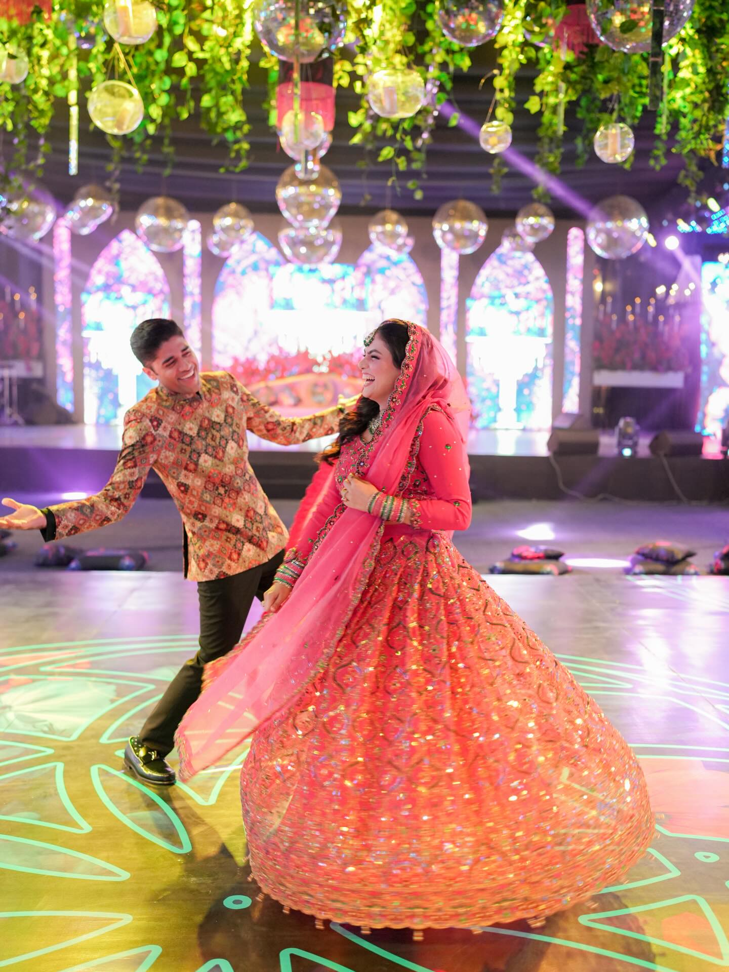 Family and guests dressed in yellow celebrating together at a haldi ceremony